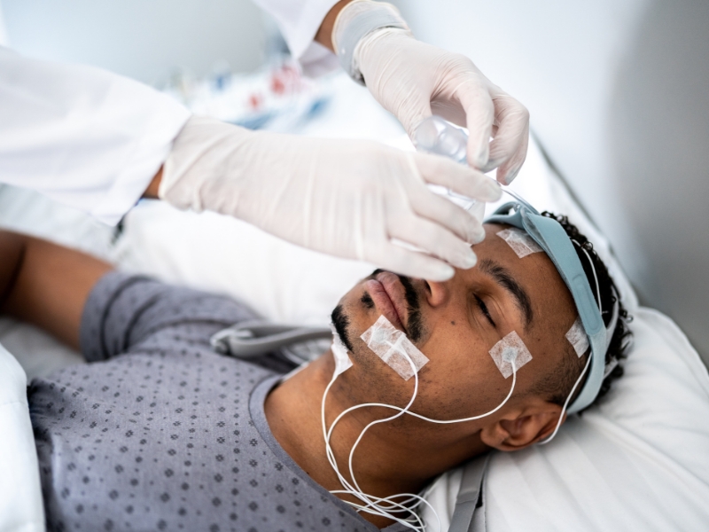 Patient in the sleep lab with sensors on his head