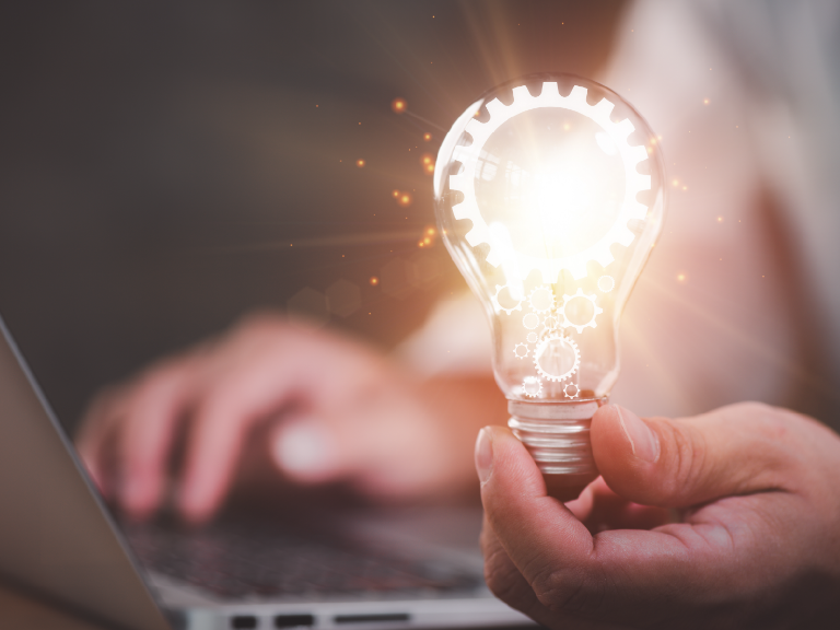 Researcher with light bulb at computer